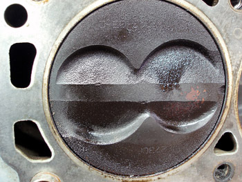 Photo 1: The even coating of carbon over the piston head indicates that the piston rings have seated.